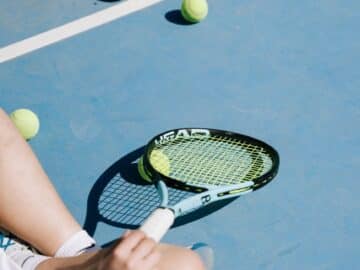 sitting woman with tennis racket and balls